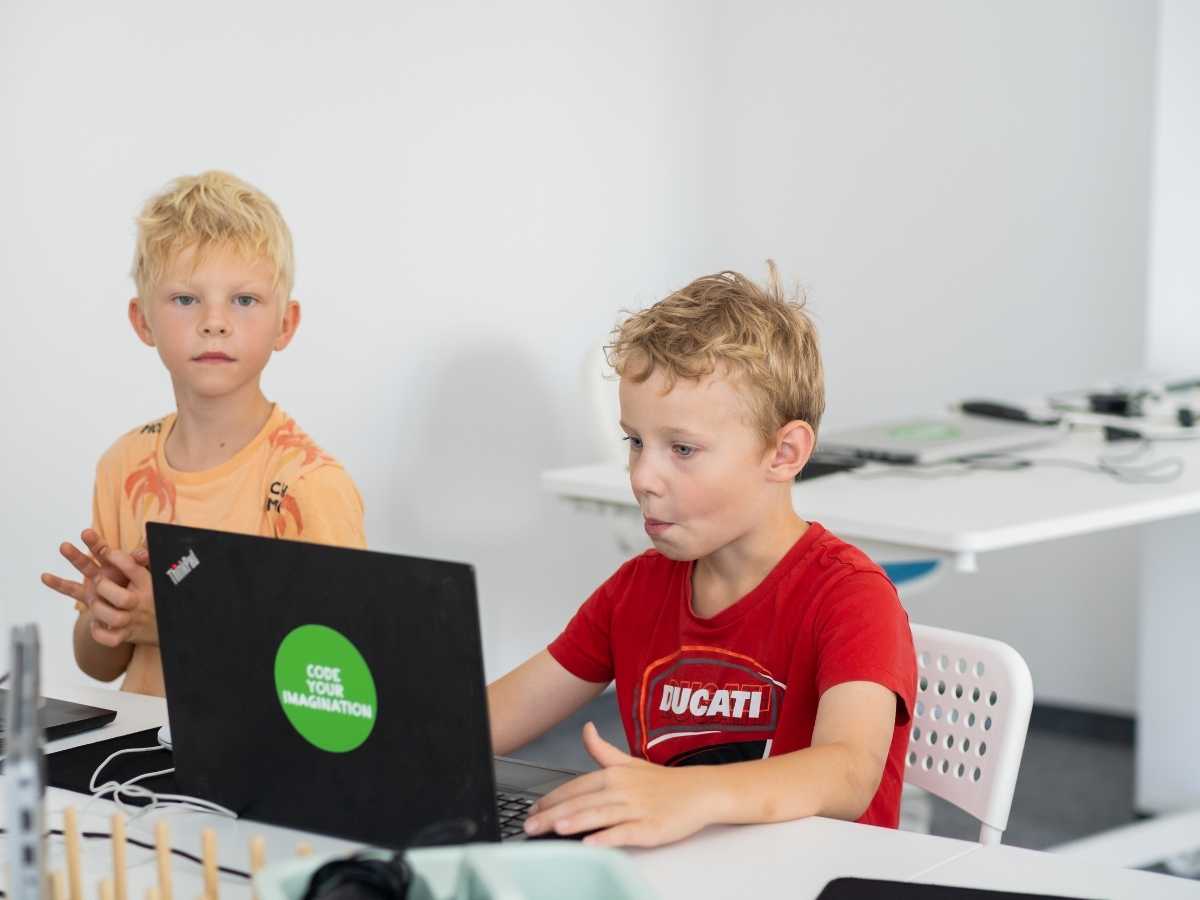 Kinder arbeiten gemeinsam am Laptop im Robbo Club Kurs