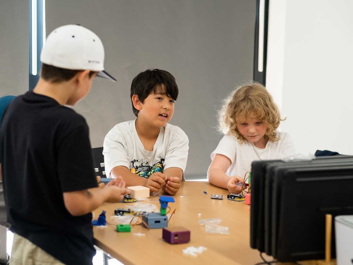 Kinder montieren gemeinsam elektronische Bauteile im Technikunterricht